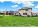 The brick home has a spacious backyard, offering a pergola-covered patio and plenty of green space at 1611 Connemara Rd, Indianapolis, IN 46217