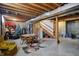 Spacious basement featuring exposed ceiling, stairs, and exercise equipment at 1611 Connemara Rd, Indianapolis, IN 46217