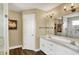 Bathroom featuring double sink vanity, modern lighting and fixtures and new flooring at 1611 Connemara Rd, Indianapolis, IN 46217