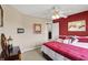 Bedroom featuring neutral walls and red accent wall, with view into hall at 1611 Connemara Rd, Indianapolis, IN 46217