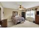 Comfortable bedroom with a ceiling fan, window, and warm colors, creating a relaxing atmosphere at 1611 Connemara Rd, Indianapolis, IN 46217