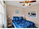 Comfortable bedroom showcasing a cozy bed, nightstands and large window with view at 1611 Connemara Rd, Indianapolis, IN 46217