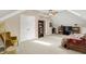 Bright bonus room featuring a cozy seating area, skylight, and functional built-in shelving at 1611 Connemara Rd, Indianapolis, IN 46217