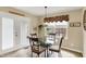 This dining area showcases a glass table, decorative light fixture, and access to a backyard through glass doors at 1611 Connemara Rd, Indianapolis, IN 46217