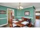 The dining room is designed with wood floors, a wood table, stylish decor, and views of the adjacent kitchen at 1611 Connemara Rd, Indianapolis, IN 46217