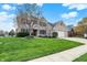 Charming two-story home featuring a brick facade, manicured lawn, and inviting curb appeal at 1611 Connemara Rd, Indianapolis, IN 46217