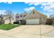 Charming two-story home with a brick facade, two car garage and beautifully manicured lawn at 1611 Connemara Rd, Indianapolis, IN 46217