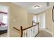Well lit upstairs hallway showing access to bedrooms and bathrooms at 1611 Connemara Rd, Indianapolis, IN 46217