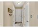 Neutral hallway features multiple doors, tile flooring, and ample lighting, creating a functional passage at 1611 Connemara Rd, Indianapolis, IN 46217
