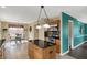 An open-concept kitchen with stainless appliances, wood cabinets, dark countertops, and access to a dining area at 1611 Connemara Rd, Indianapolis, IN 46217