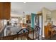 A kitchen with dark countertops, wood cabinets, stainless appliances, and barstool seating overlooks an open dining area at 1611 Connemara Rd, Indianapolis, IN 46217