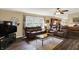 Cozy living room with hardwood floors, comfortable leather seating, and large windows for natural light at 1611 Connemara Rd, Indianapolis, IN 46217