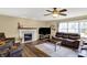 Comfortable living room with a fireplace, large windows, hardwood floors, and plush seating at 1611 Connemara Rd, Indianapolis, IN 46217