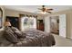 Serene main bedroom with natural light, a ceiling fan, and ensuite bathroom access for convenience at 1611 Connemara Rd, Indianapolis, IN 46217