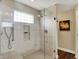 Walk-in shower with glass enclosure and tiled walls and bench seat at 1611 Connemara Rd, Indianapolis, IN 46217
