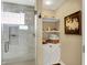 The walk-in shower has a glass enclosure and tiled walls with built in niche at 1611 Connemara Rd, Indianapolis, IN 46217