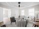 Bright living room featuring modern decor, wood flooring, and plenty of natural light from large windows at 1613 E Ohio St, Indianapolis, IN 46201