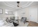 Bright living room with modern decor, recessed lighting, ceiling fan, and an open layout to the kitchen at 1613 E Ohio St, Indianapolis, IN 46201
