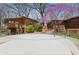 Backyard view of wooden house with an above ground pool surrounded by beautiful flowering trees at 16632 Oak Rd, Westfield, IN 46074