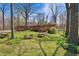 Spacious backyard with lush lawn, mature trees, and charming picnic tables, perfect for outdoor gatherings at 16632 Oak Rd, Westfield, IN 46074