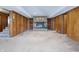 The finished basement has a fireplace with a brick surround and hearth, with decorative items and wood paneled walls at 16632 Oak Rd, Westfield, IN 46074