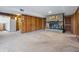 The finished basement has a fireplace with a brick surround and hearth, with decorative items and wood paneled walls at 16632 Oak Rd, Westfield, IN 46074