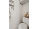 Cozy half-bathroom featuring a toilet with a basket of towels, offering both function and comfort at 16632 Oak Rd, Westfield, IN 46074