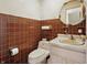 Powder room featuring brown tile walls and a vintage sink at 16632 Oak Rd, Westfield, IN 46074