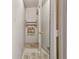 Narrow bathroom hallway featuring a towel rack and mirrored wall, offering practicality and efficient space at 16632 Oak Rd, Westfield, IN 46074