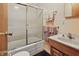 Well-lit bathroom featuring a shower with sliding glass doors, a white sink and wood vanity, and neutral wall paint at 16632 Oak Rd, Westfield, IN 46074