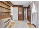 This bedroom features warm wood paneled walls, built in shelving, and access to an adjacent bathroom and hall at 16632 Oak Rd, Westfield, IN 46074