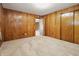 This bedroom features warm wood paneled walls, access to an adjacent room, and a closet at 16632 Oak Rd, Westfield, IN 46074
