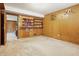 This bedroom features warm wood paneled walls, and shelving for displaying items with access to an adjacent room at 16632 Oak Rd, Westfield, IN 46074