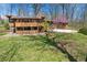 Landscaped yard with mature trees, a deck, and a unique partially covered area at 16632 Oak Rd, Westfield, IN 46074