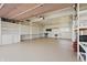 Spacious garage with storage and shelving perfect for any hobbyist or car enthusiast at 16632 Oak Rd, Westfield, IN 46074