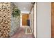 Inviting hallway featuring a stone accent wall, wood paneling, and neutral carpeting at 16632 Oak Rd, Westfield, IN 46074