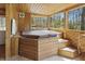 Relaxing hot tub in an enclosed patio with wood paneling, offering a private space for unwinding and enjoying leisure time at 16632 Oak Rd, Westfield, IN 46074