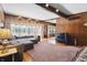 Spacious living room with wood paneling, large windows, and a comfortable sectional sofa at 16632 Oak Rd, Westfield, IN 46074