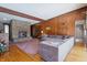Spacious living room featuring a stone fireplace and wood paneling at 16632 Oak Rd, Westfield, IN 46074