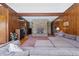 Inviting living room with a stone fireplace, wood paneling, and a large sectional sofa, perfect for cozy gatherings at 16632 Oak Rd, Westfield, IN 46074