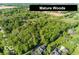 Aerial view of wooded acreage with mature trees and well-maintained lawn surrounding the houses at 16632 Oak Rd, Westfield, IN 46074