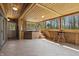 Sunroom with wood paneling, tile floor, hot tub and windows providing natural light and beautiful views of the outdoors at 16632 Oak Rd, Westfield, IN 46074