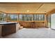 Enclosed patio with wood paneling, hot tub, tile flooring, and large windows providing natural light and views at 16632 Oak Rd, Westfield, IN 46074