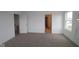 Unfurnished bedroom with neutral carpet, white walls and trim, plus a window view of the outdoors at 17039 Silo Ridge Way, Noblesville, IN 46060
