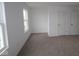 This bedroom features neutral carpeting, natural light from two windows, and two doors for easy access at 17039 Silo Ridge Way, Noblesville, IN 46060