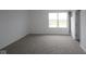 Unfurnished bedroom with neutral carpet, white walls and trim, with a window view of the outdoors at 17039 Silo Ridge Way, Noblesville, IN 46060