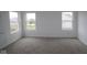 Unfurnished bedroom with a neutral carpet, white walls, three windows, and white trim at 17039 Silo Ridge Way, Noblesville, IN 46060
