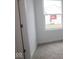Small unfurnished bedroom with neutral carpet, white walls and trim, plus a window view of the outdoors at 17039 Silo Ridge Way, Noblesville, IN 46060