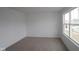 Unfurnished bedroom with a neutral carpet, white walls, one large window, and white trim at 17039 Silo Ridge Way, Noblesville, IN 46060