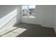 Bright bedroom featuring neutral carpet, white walls, and large window for plenty of natural light at 17062 Cowbell Dr, Noblesville, IN 46060